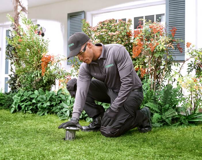 Terminix technician working in a yard