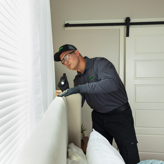 TMX tech checking behind couch