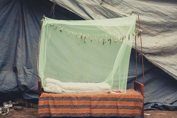 Mosquito net over a bed outdoors