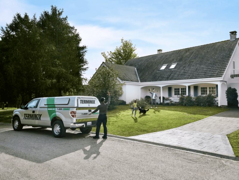 Terminix technician approaching residential home