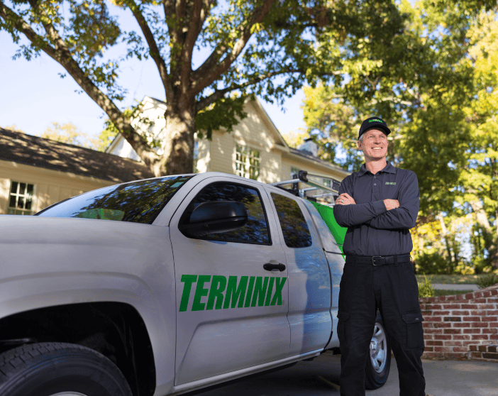 Terminix tech standing in front of Terminix truck