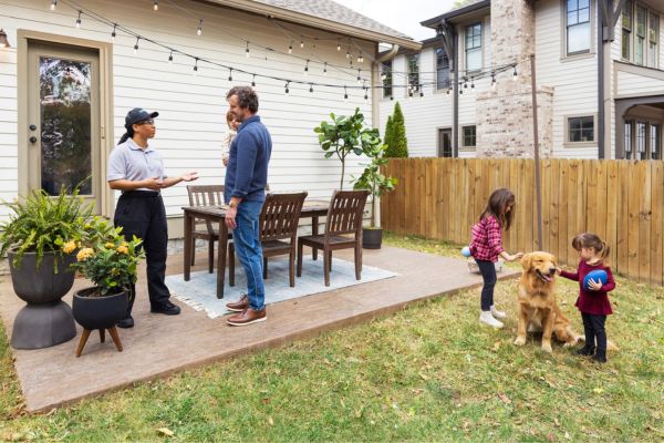 Terminix bee expert talking to family outside