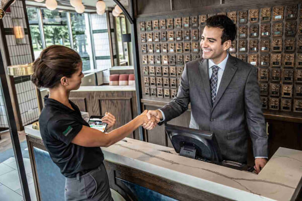 Terminix tech shaking hands with hotel employee