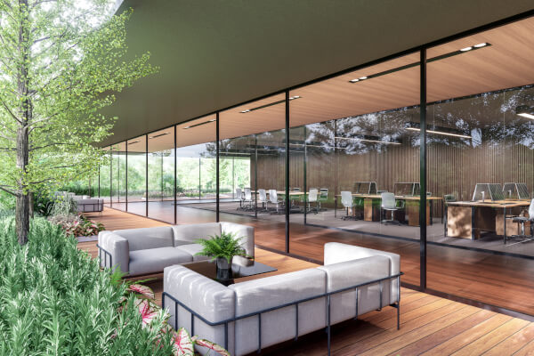 Outside sitting area by office building lined by greenery