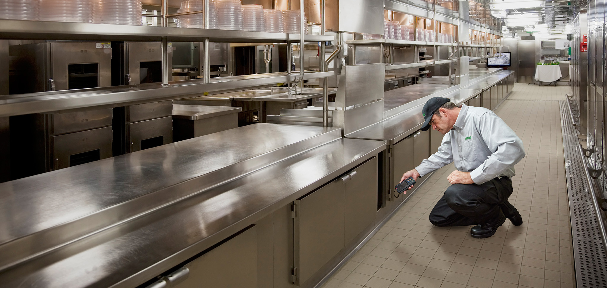 technician looking in kitchen