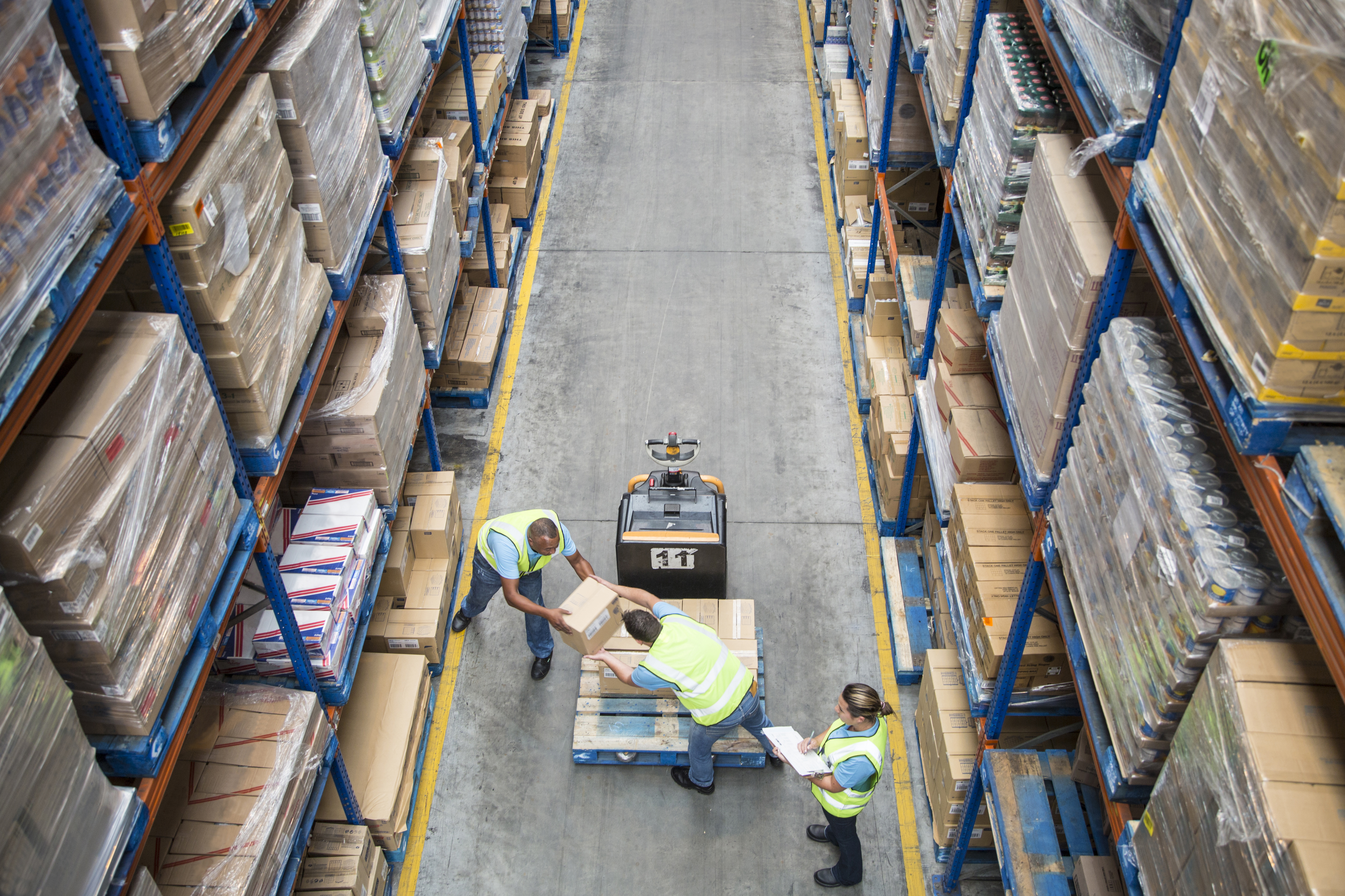 people moving boxes at warehouse
