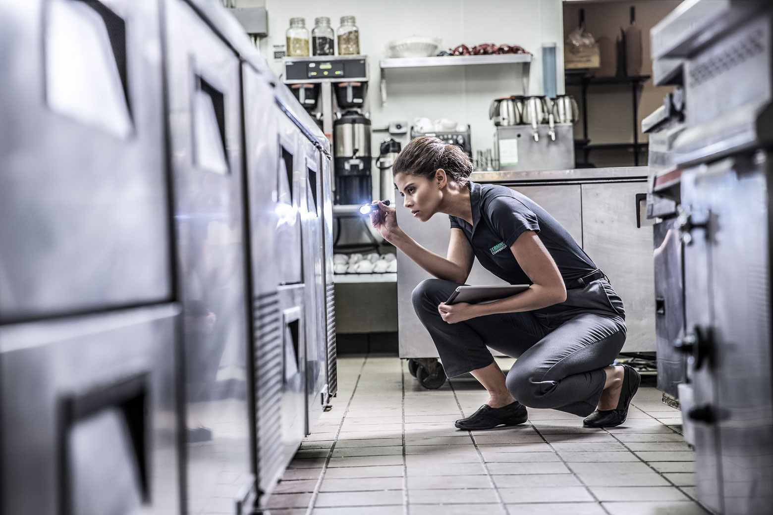 terminix technician inspecting a restaurant kitchen
