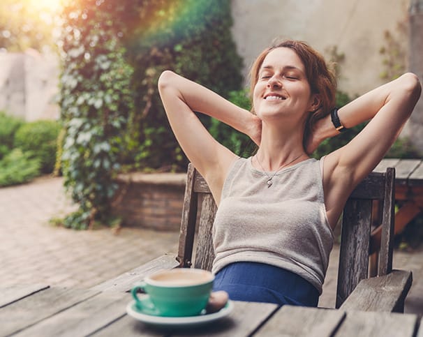 woman sitting outside having coffee