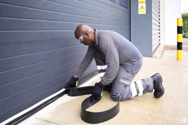 tech installing flexi armor on garage door