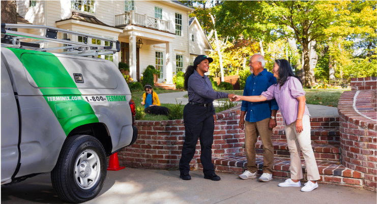 Terminix technician speaking with homeowners