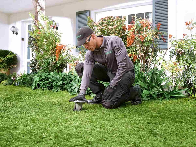 technician installing termite bait station