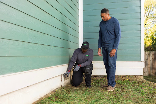 Technician crouching with customer 