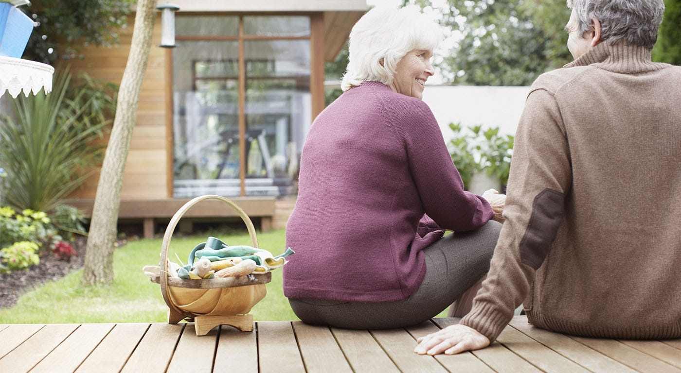grandmother and grandfather sitting on steps outside