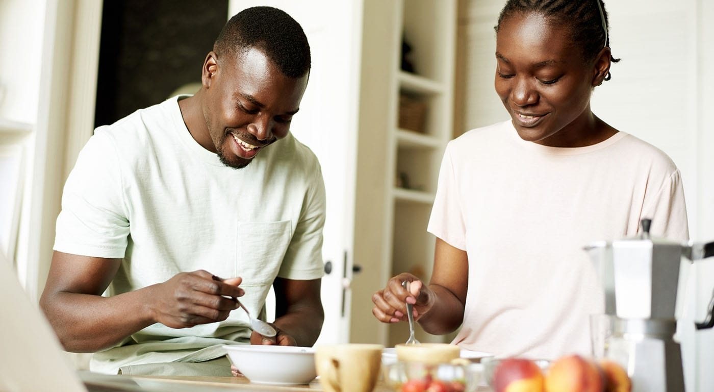 man and woman eating breakfast at table