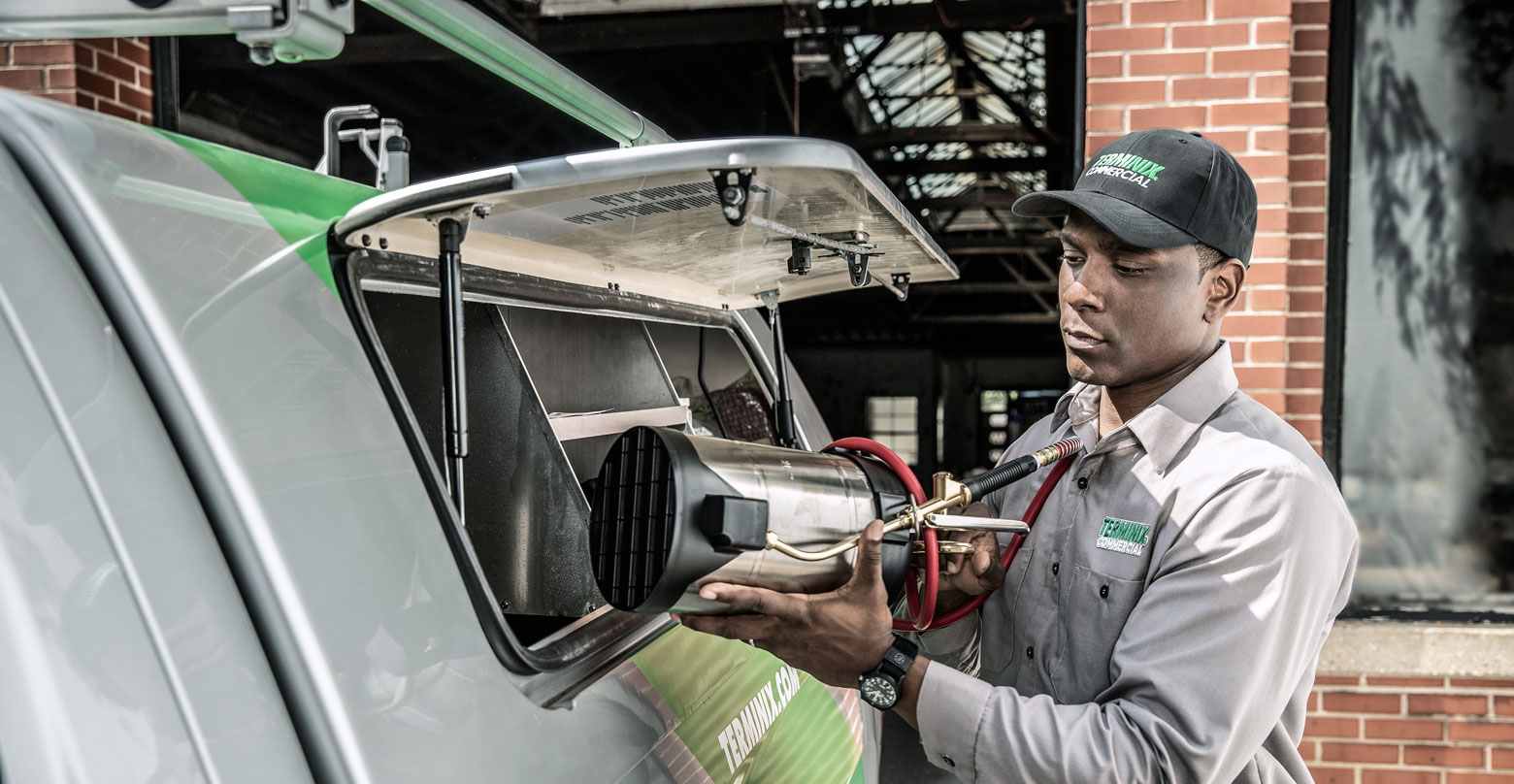 technician getting machine from terminix truck