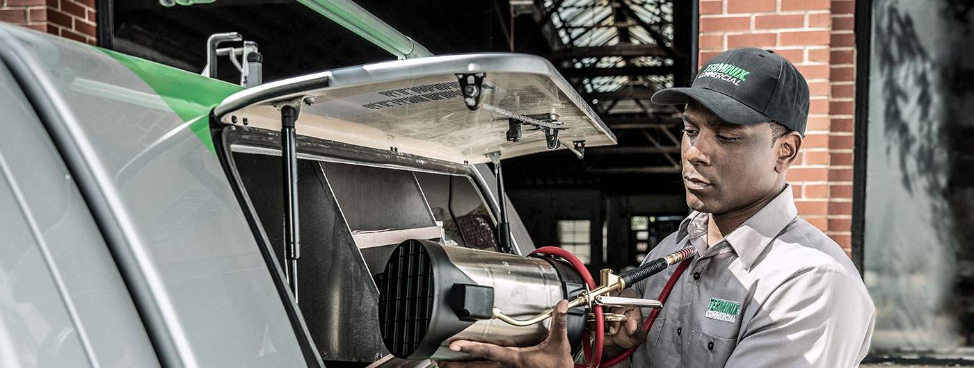 terminix technician getting equipment out of the truck