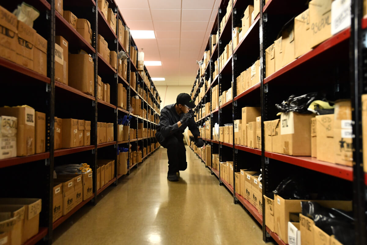Terminix tech conducting inspection of boxes in warehouse