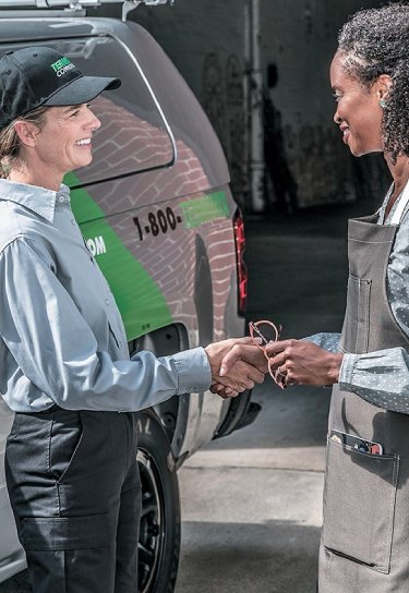 terminix agent shaking hands with business owner