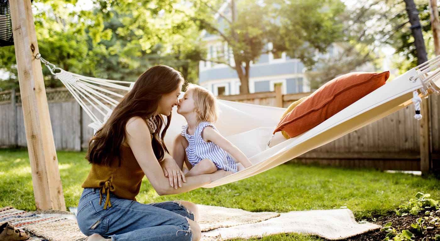 Woman and little girl sitting outside