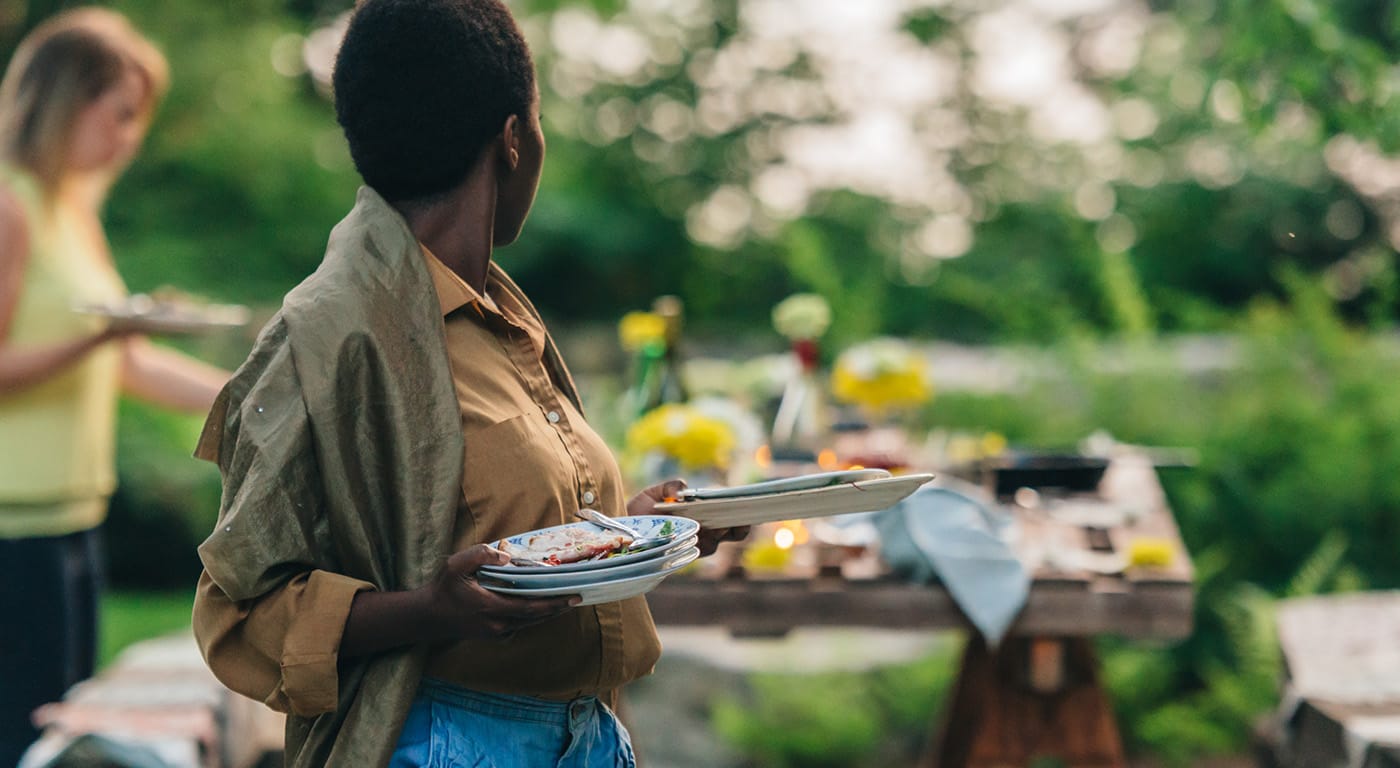 person carrying plates outdoors