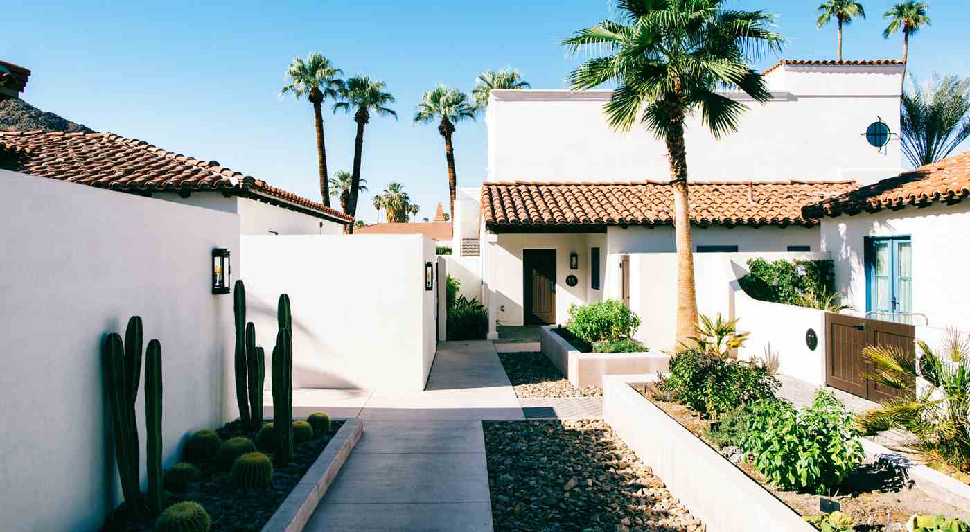 house in desert with palm trees