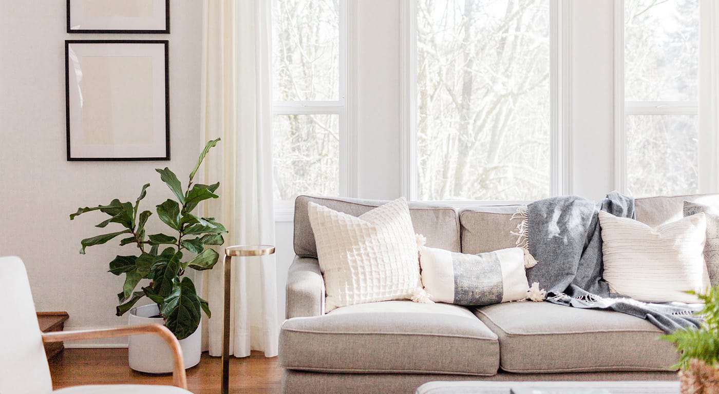 living room with a gray couch and hardwood floors