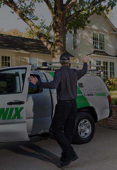 Terminix technician waving to customers